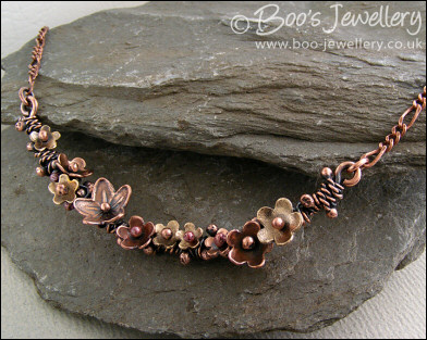 Copper and bronze necklace wrapped with buds and flowers