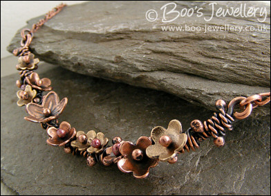 Copper and bronze necklace wrapped with buds and flowers