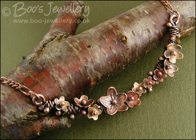 Copper and bronze necklace wrapped with buds and flowers