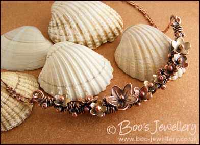 Copper and bronze necklace wrapped with buds and flowers