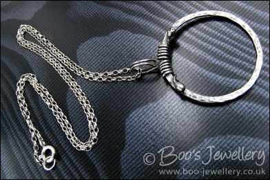 Hammered silver circle pendant with tendril bail