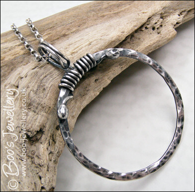 Hammered silver circle pendant with tendril bail