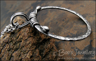 Hammered silver circle pendant with tendril bail