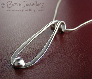 Sterling silver teardrop pendant with pebble of silver