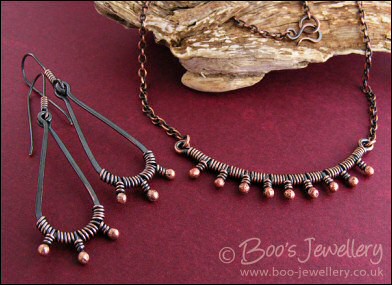 Long dark teardrop earrings with rosy buds