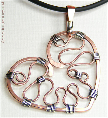Hammered copper heart with silver wrapping on a chain
