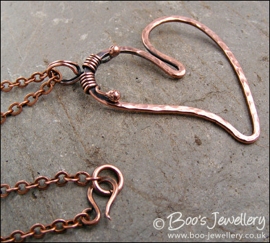 Hammered copper heart pendant with tendril bail