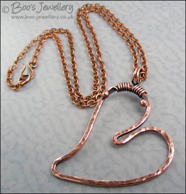 Hammered copper heart pendant with tendril bail