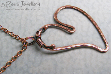 Hammered copper heart pendant with tendril bail